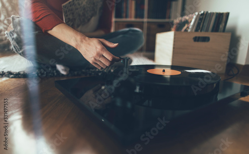 Принти на полотні Close up of audiophile hand playing vinyl record on turntable