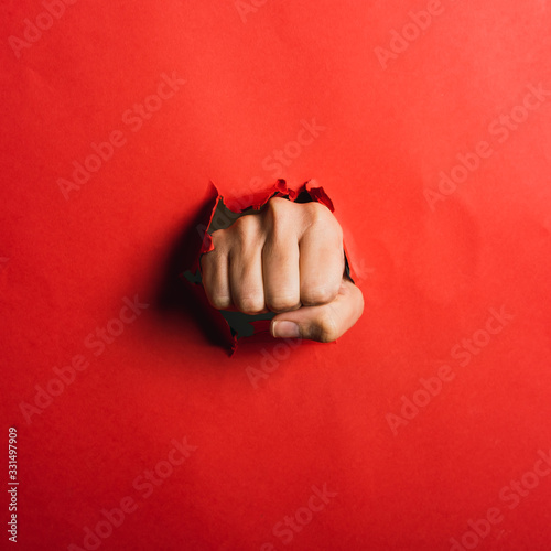 Canvas Print Human hand tearing red paper with the word coronavirus, concept in the fight aga