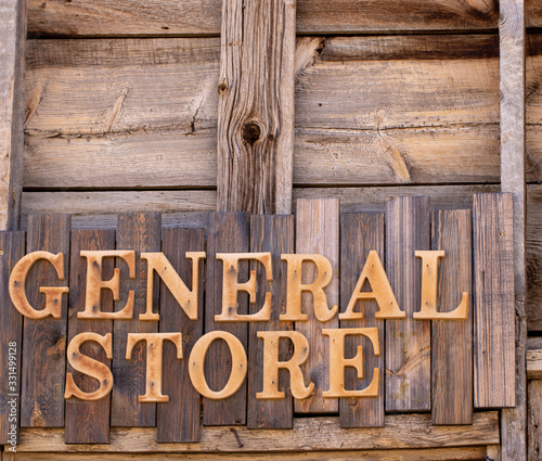 Fotografi Wooden General Store sign against wooden planks