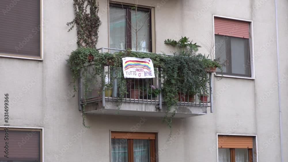 Europe, Italy, Milan March 2020, Coronavirus emergency - On the windows of the city hang sheets designed by children with rainbow and the words 
