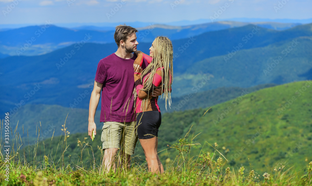 Love and trust. Romantic relations. Journey to mountains concept. Honeymoon in highlands. Two hearts full of love. Beautiful couple embracing landscape background. Couple in love summer vacation