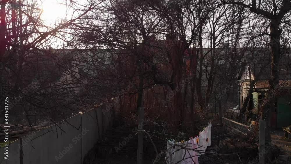 House yard drone take off drying clothes dry trees and abandoned barn sun glare House yard drone take off drying clothes dry trees and abandoned barn sun glare
