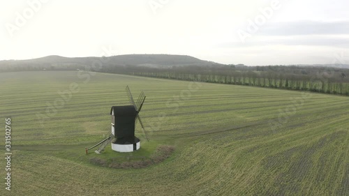 Drone reverse shot of old windmill photo