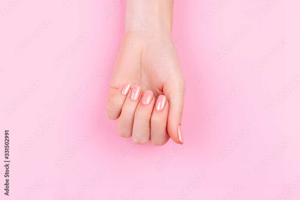 Beautiful Woman Hands with fresh eustoma. Spa and Manicure concept. Female hands with pink manicure. Soft skin, skincare concept. Beauty nails. Over beige background Beautiful Woman Hands with fresh eustoma. Spa and Manicure concept. Female hands with pink manicure. Soft skin, skincare concept. Beauty nails. Over beige background