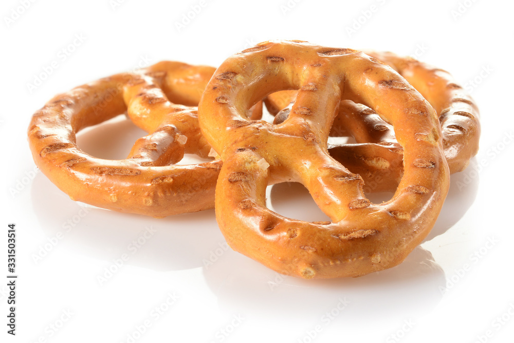 Pretzels, three mini snacks with salt for beer. Savory backed beer snack. Macro close-up isolated on white background, side view Pretzels, three mini snacks with salt for beer. Savory backed beer snack. Macro close-up isolated on white background, side view