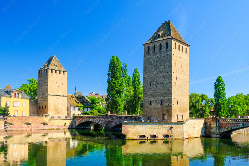 Strasbourg, Alsace, France. Old towers on the Ponts Couverts bridge over the Ill river.