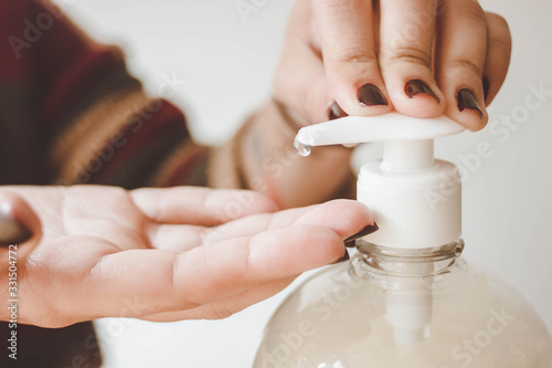 detail shot of hands using antibacterial to clean virus