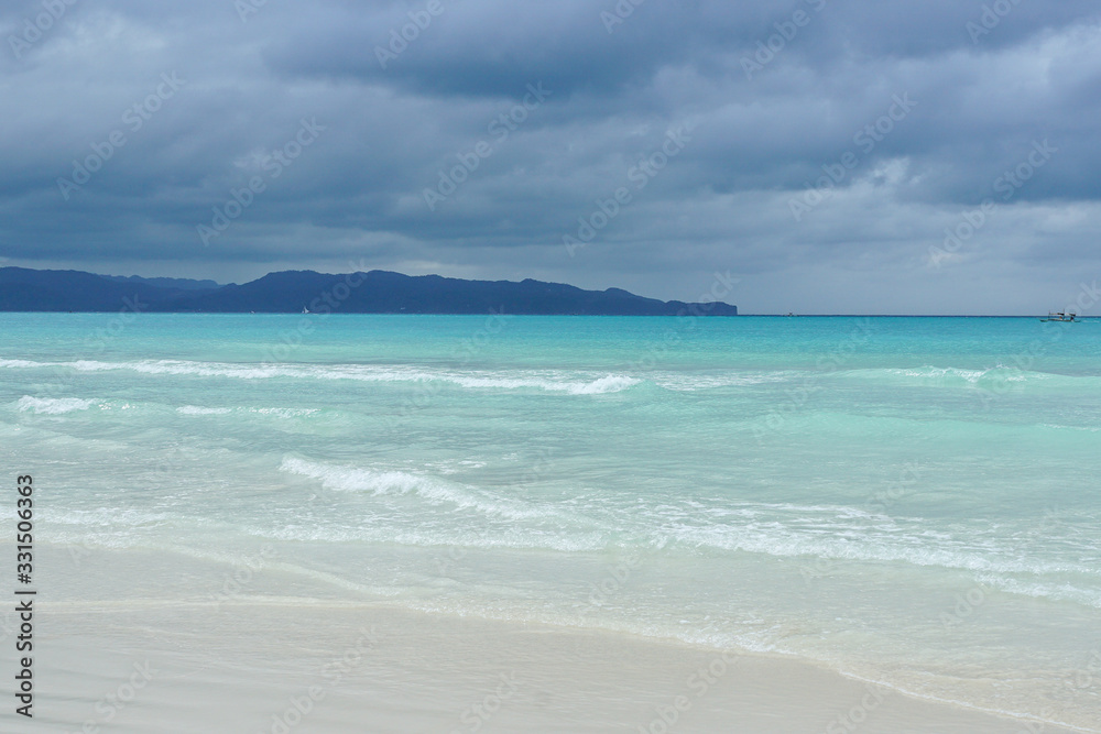 turquoise sea, white sand, dark sky after storm, mountains on the horizon. paradise tropical island, vocation concept. Boracay island, white baech, Phillipines turquoise sea, white sand, dark sky after storm, mountains on the horizon. paradise tropical island, vocation concept. Boracay island, white baech, Phillipines