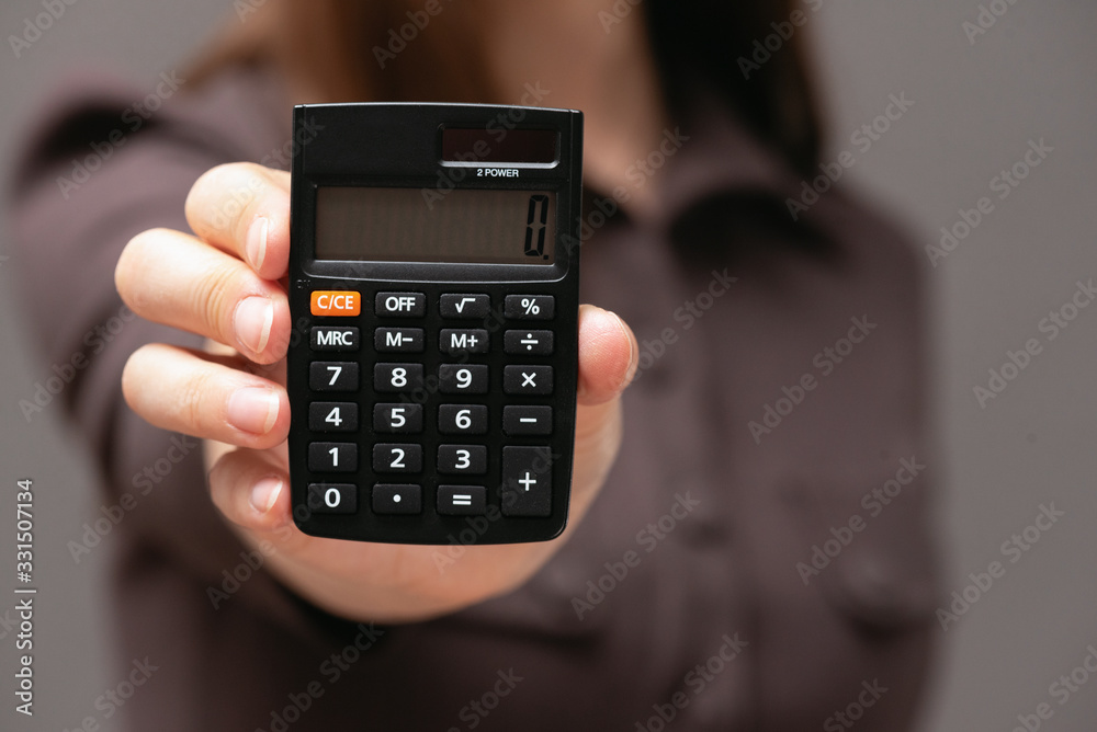Calculator with zero on the display in business lady hands close up. Calculator with zero on the display in business lady hands close up.
