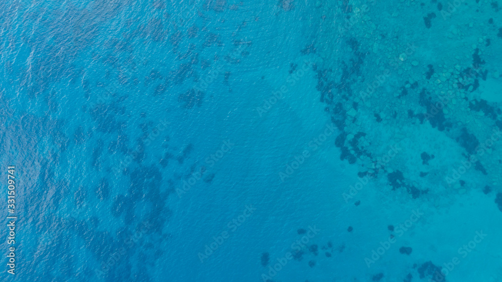 Blue tropical clear sea surface with waves and ripples. View from drone.