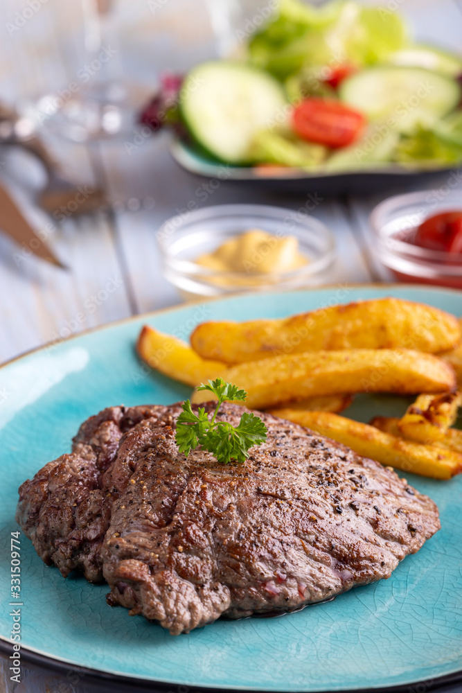 steak on a plate with french fries steak on a plate with french fries