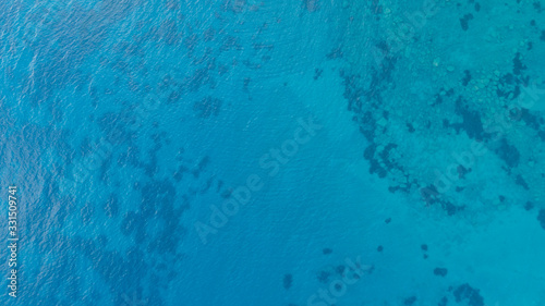 Blue tropical clear sea surface with waves and ripples. View from drone.