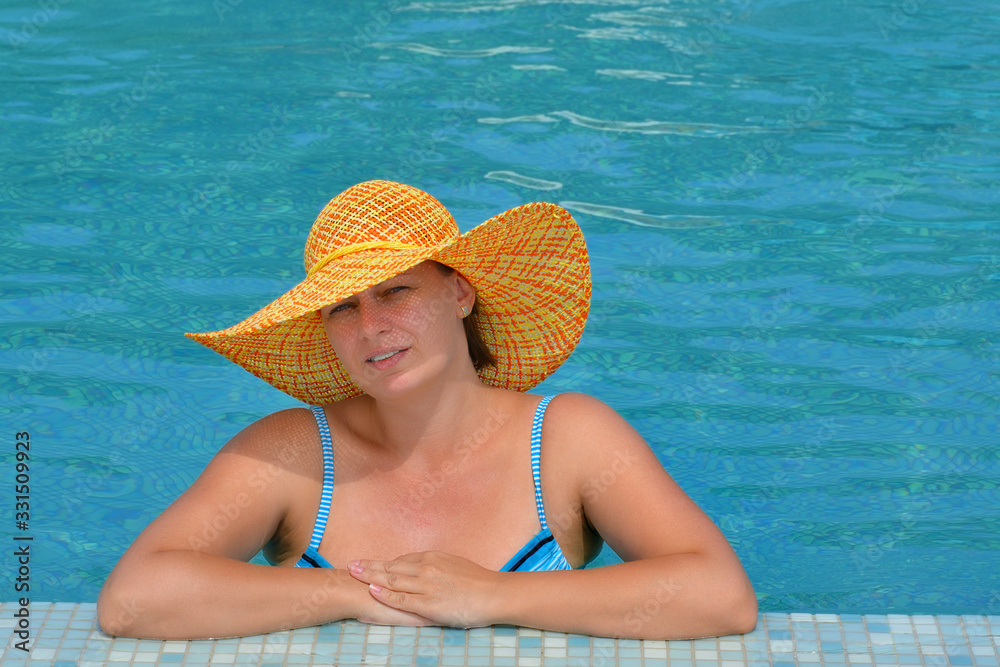 Real female beauty relaxing in swimming pool