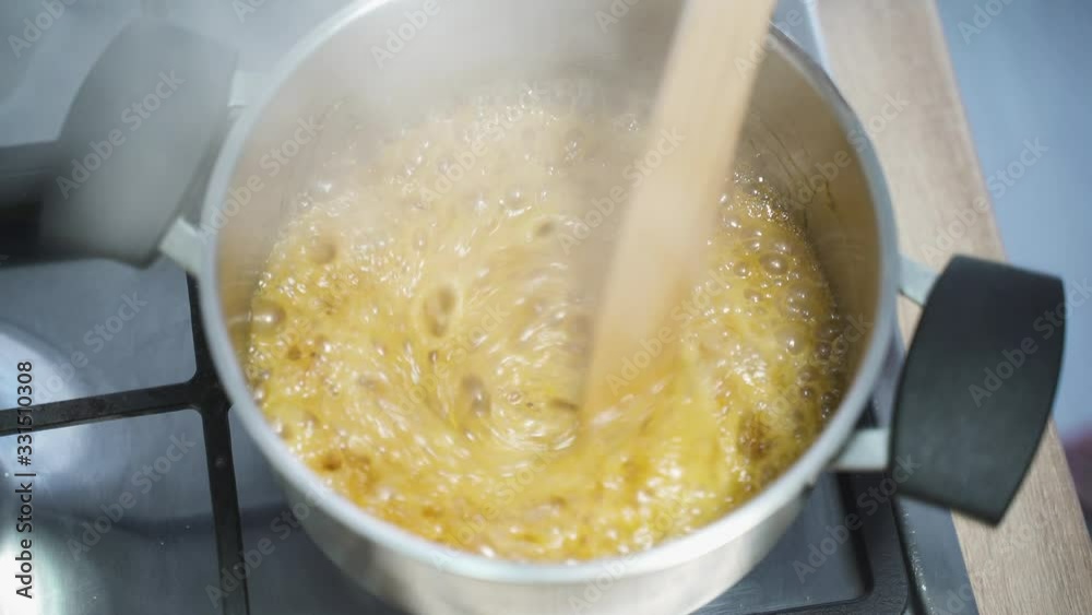 Creamy caramel cooking in the kitchen in a pot Creamy caramel cooking in the kitchen in a pot