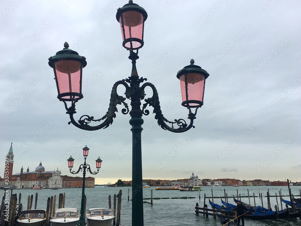 Street lamp on the background of the Venetian lagoon. Traveling to in Italy.