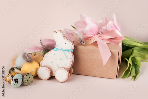 Beautiful Easter composition of eggs with natural colors, gingerbread, flowers, feathers.