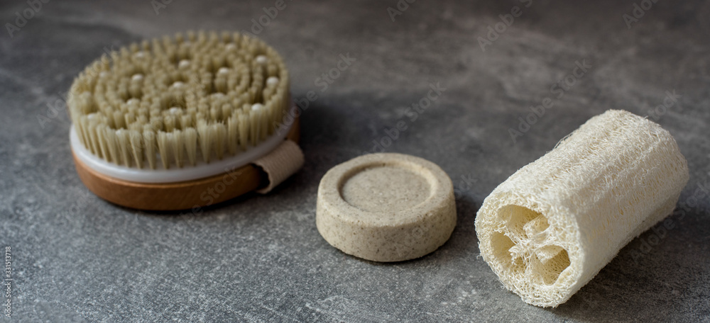 Loofah, solid shampoo, brush body sponge for zero waste washing or bath on grey background