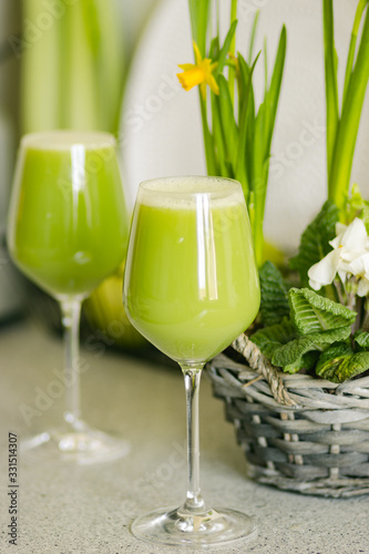 Healthy refreshing drink of juicy green celery with cucumber and apple