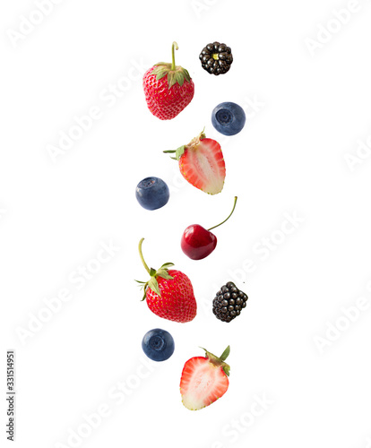 Isolated fresh berries float in the air. Falling blackberry, blueberry, cherry and strawberry fruits isolated on white background with clipping path. Mixed berries with a copy space for text.
