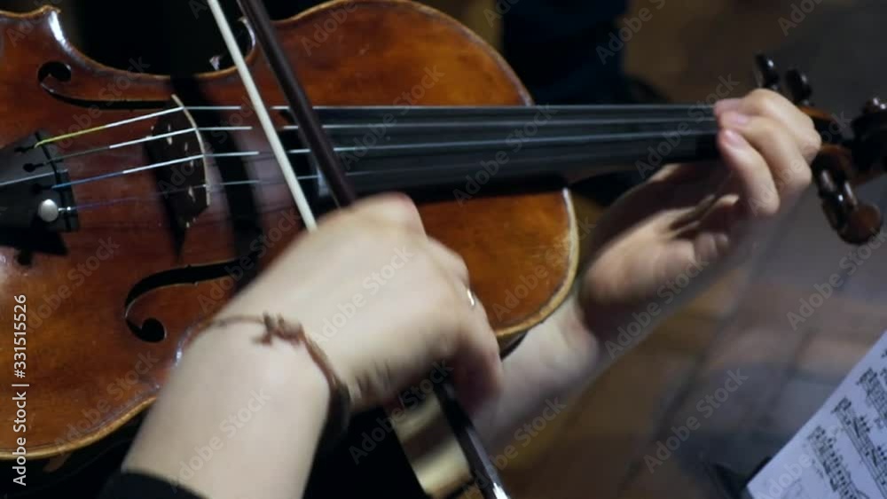 close-up video of a violinist's hands playing the violin or viola close-up video of a violinist's hands playing the violin or viola