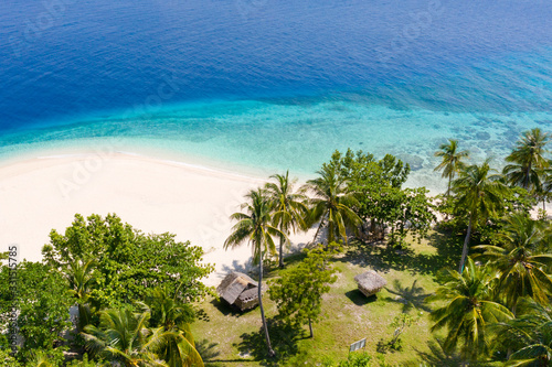 Tropical island with a beach and palm trees. Mahaba Island, Philippines.