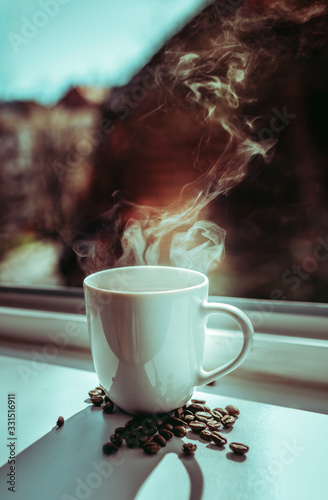 cup of hot coffee, steam, coffee grains