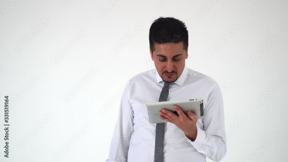 A satisfied man looks at a digital tablet and is upset by what he saw. The distressed man raises his eyebrows and grabs his head A satisfied man looks at a digital tablet and is upset by what he saw. The distressed man raises his eyebrows and grabs his head