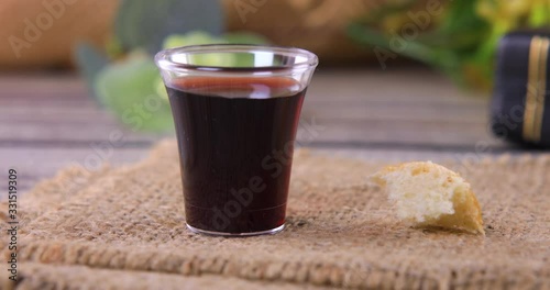 Taking communion concept - the wine and the bread symbols of Jesus Christ blood and body with Holy Bible. Easter Passover and Lord Supper concept. Dolly shot 4k