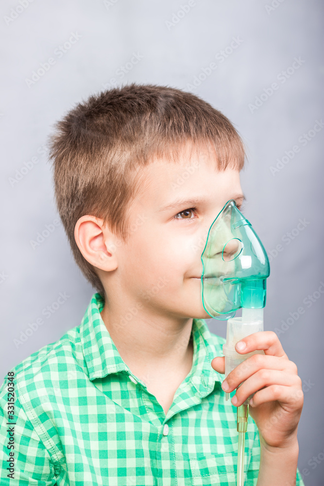 Boy hold a mask of a nebulizer