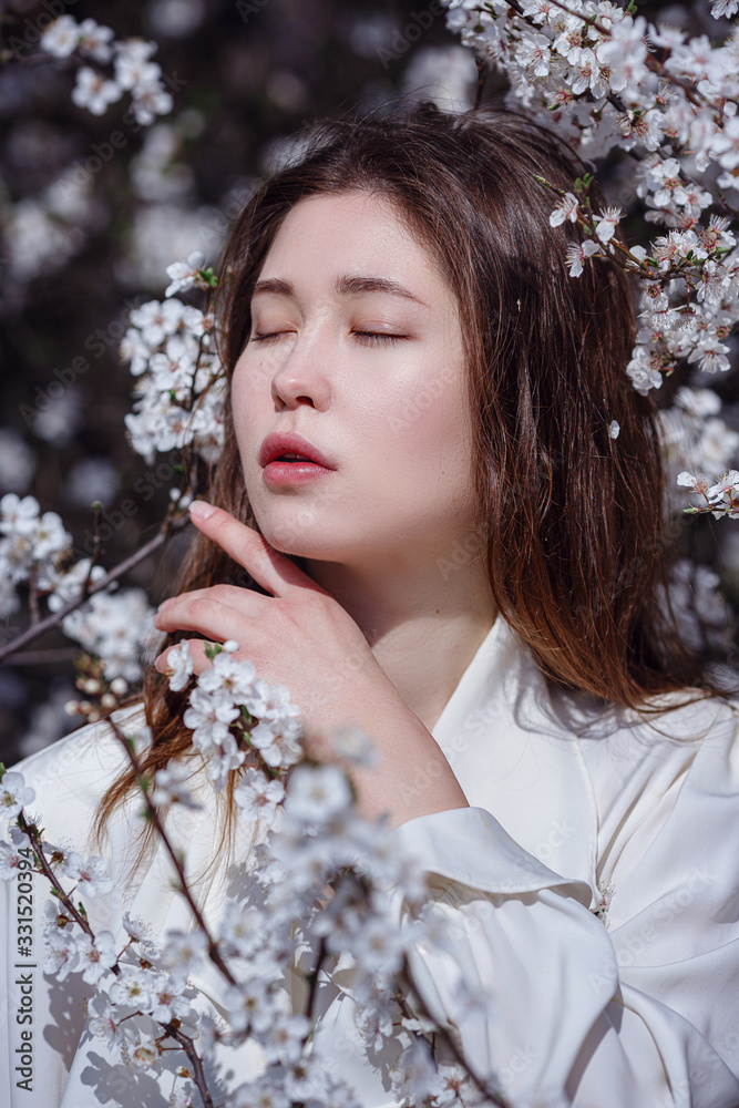 young asian woman in a flowering garden young asian woman in a flowering garden