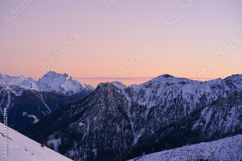 sunset in the alps with snow covered mountains