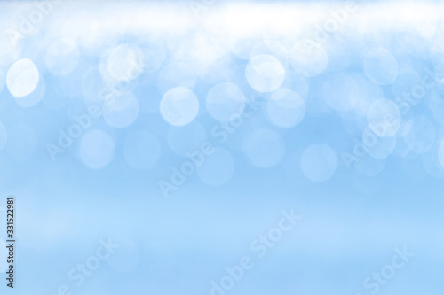 Abstract light blue background with white bokeh above_