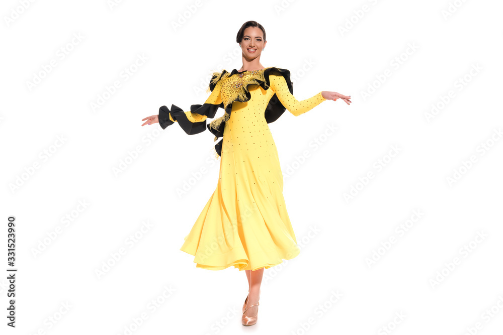 smiling elegant young ballroom dancer in yellow dress dancing isolated on white smiling elegant young ballroom dancer in yellow dress dancing isolated on white