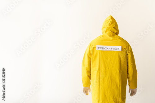 New coronavirus - 2019 nkoV virus concept, WUHAN. sick among the crowd. one person is standing on a white background wearing a yellow protective suit. photo