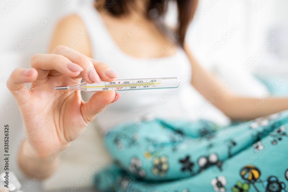 Sick woman with flu, cold, fever at home Sick woman with flu, cold, fever at home