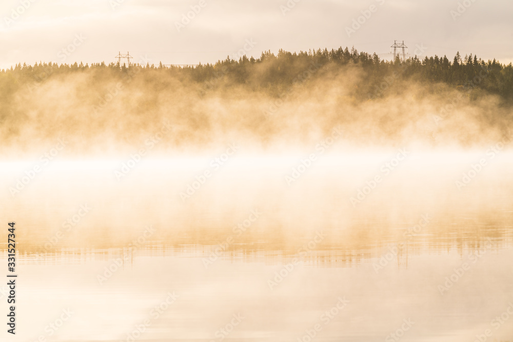 Mist on calm lake, Sweden.