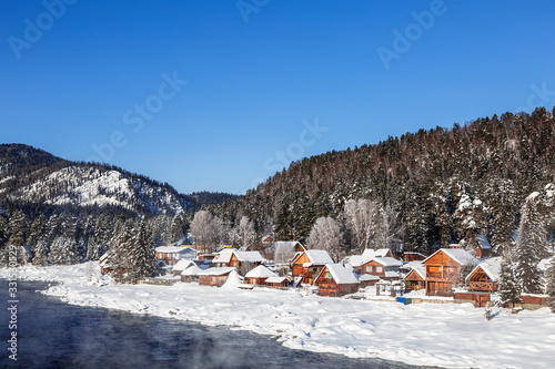 View of the winter Altai with the Biya river, Artybash village and mountains on the horizon. Altai Republic, Russia