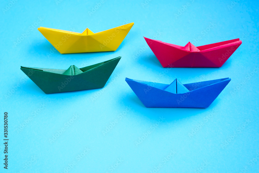 Bright colored origami paper boats.