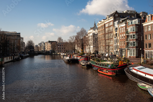 old house in Amsterdam city center with canals and boats