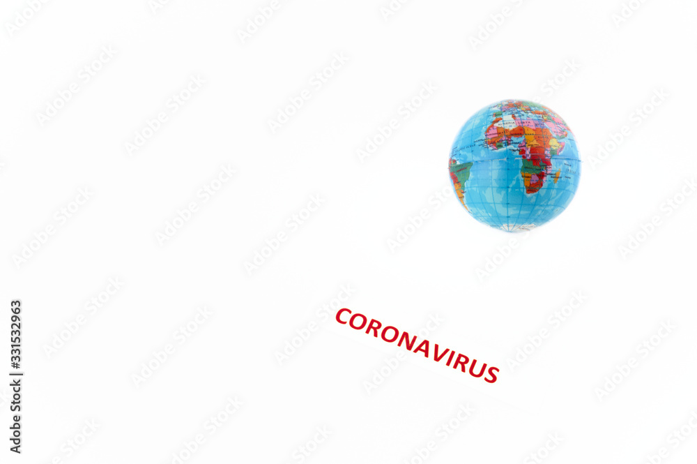 Coronavirus label next to the world globe