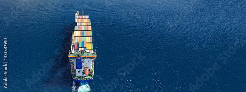 Aerial drone top down photo of fully loaded large truck size container tanker ship cruising the Mediterranean deep blue sea © aerial-drone