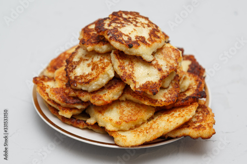 fried cottage cheese cakes on a plate on a gray background