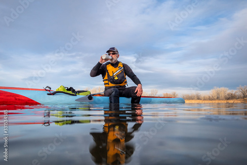 senior male with stand up paddleboard