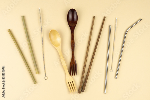 Eco food items. Wooden spoon and fork. Iron tubules for drinks with brushes for cleaning.