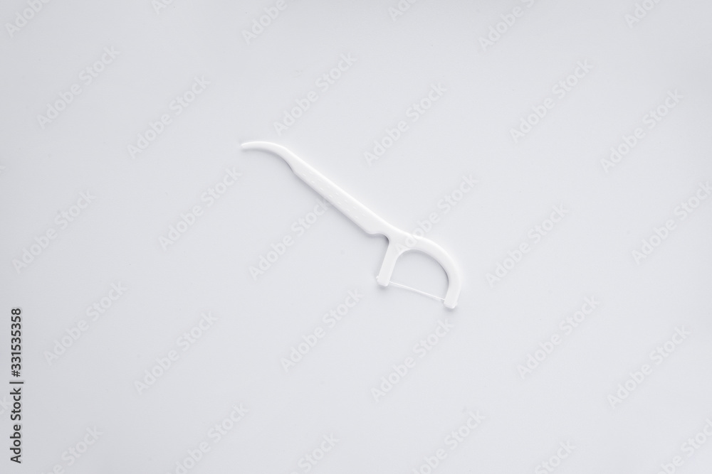 Flat lay composition of white toothpicks with thread on a white background. Flat lay composition of white toothpicks with thread on a white background.