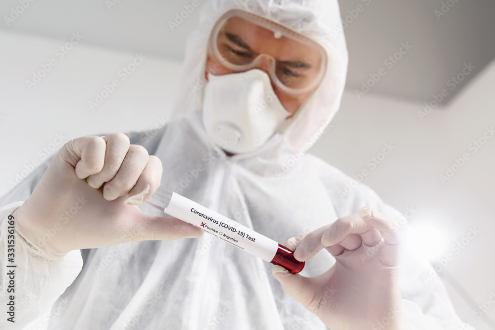 Pandemic covid-19. A virologist doctor holding a patient’s blood sample in test tube. Disease vaccine development Pandemic covid-19. A virologist doctor holding a patient’s blood sample in test tube. Disease vaccine development