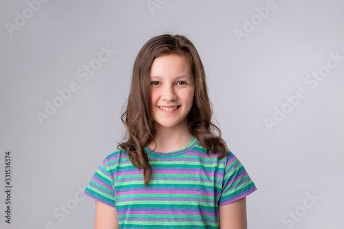 Portrait of cheerful little girl showing thumbs up