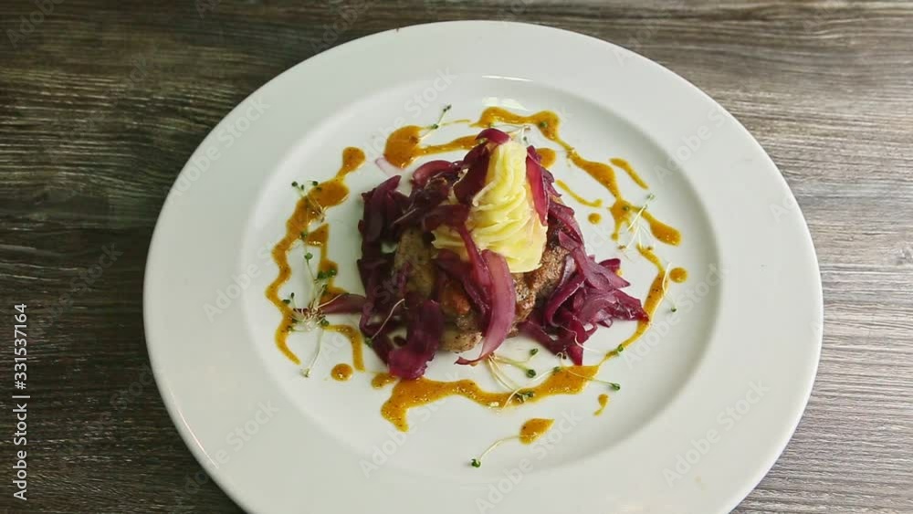 slow zoom in at fried meat pieces with mashed potato and sliced onion slow zoom in at fried meat pieces with mashed potato and sliced onion