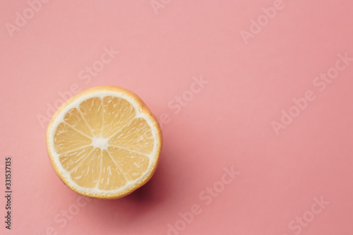 Sliced lemon on pink background. Minimal concept. Summer minimal concept. Flat lay.