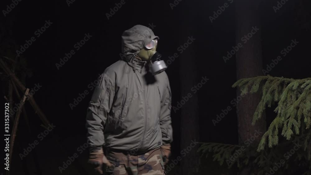 man in a gas mask escapes from coronavirus in the woods at night man in a gas mask escapes from coronavirus in the woods at night